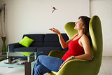 Woman home owner playing with keys of new house on sofa