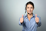 Attractive call center operator giving thumbs up