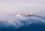 Large cargo ships in partial fog
