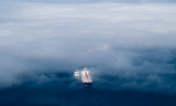 Cargo ships emerging from fog