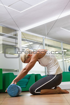Side view of woman doing fitness exercise in gym