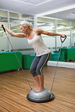 Woman doing fitness exercise in fitness studio