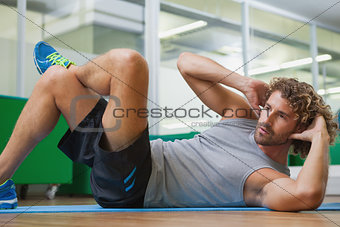 Handsome young man doing fitness exercise