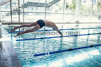 Swimmer diving into the pool at leisure center