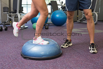 Low section of couple exercising at gym