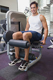 Fit man using weights machine for legs