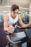 Fit man working out on the exercise bike