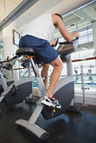 Fit man working out on the exercise bike