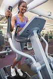Fit woman working out on the cross trainer