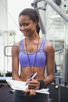 Fit personal trainer smiling at camera