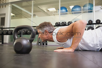 Fit man using kettlebells in his workout