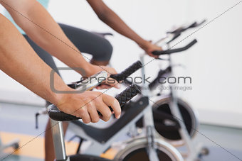 Fit people working out on the exercise bikes