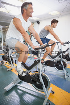 Fit people working out on the exercise bikes