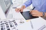 Graphic designer using digitizer at his desk