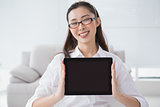 Businesswoman sitting and showing tablet