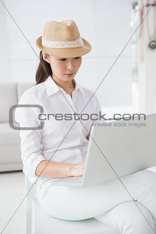 Hipster businesswoman sitting and using laptop