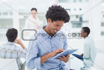 Casual businessman using his tablet