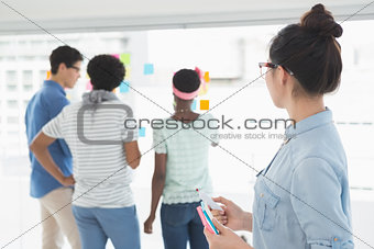 Young creative woman looking at team