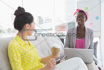 Young creative women chatting on the couch