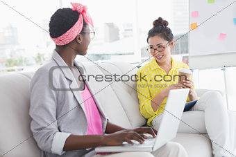 Young creative women chatting on the couch