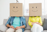 Young creative team wearing boxes on head