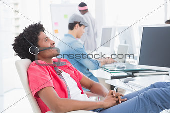 Young creative man listening to music