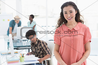 Young creative woman smiling at camera