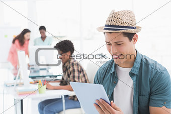 Young creative man using his tablet
