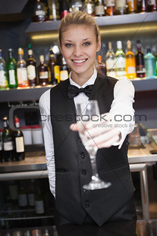 Pretty woman offering flute of champagne
