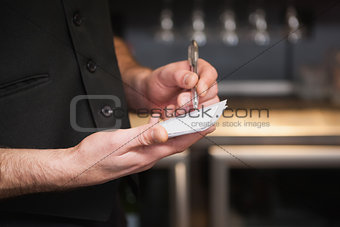 Waiter taking order in his notepad