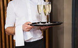 Waiter holding tray of champagne