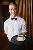Waiter holding tray with coffee cup