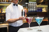 Attractive bar man making a cocktail
