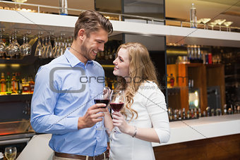 Lovely couple enjoying red wine