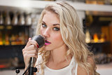 Young blonde woman singing while looking at camera