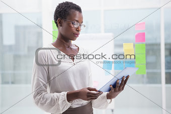 Businesswoman with glasses using tablet