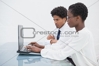 Concentrated team using laptop and thinking