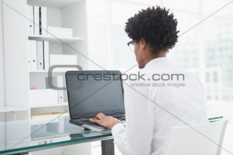 Businessman in shirt using laptop