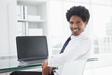 Portrait of a smiling businessman at desk