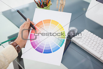 Designer working at desk using a colour wheel