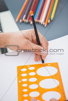 Designer drawing circle on paper
