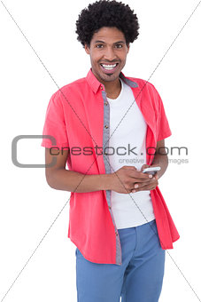 Happy causal man holding smartphone