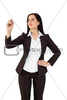 Pretty businesswoman writing with marker