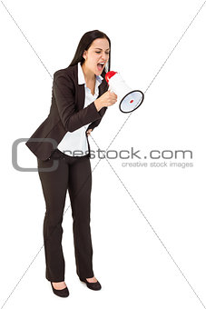 Pretty businesswoman shouting with megaphone