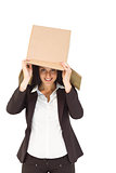 Businesswoman lifting box off head