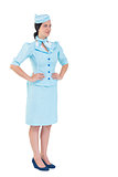 Pretty air hostess with hands on hips