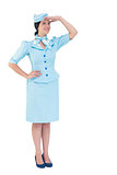 Pretty air hostess with hand on hip