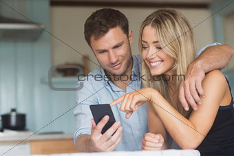 Cute couple using smartphone together