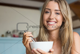 Cute blonde having cereal for breakfast