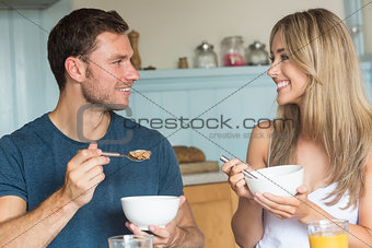 Cute couple having cereal for breakfast